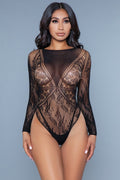 Model wearing a black lace bodysuit against a gray background