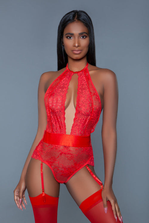 Model wearing a red lace lingerie set against a gray background