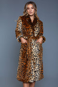 Woman wearing a leopard print dress against a gray background