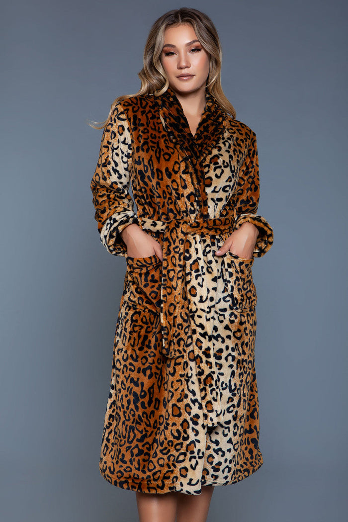 Woman wearing a leopard print dress against a gray background