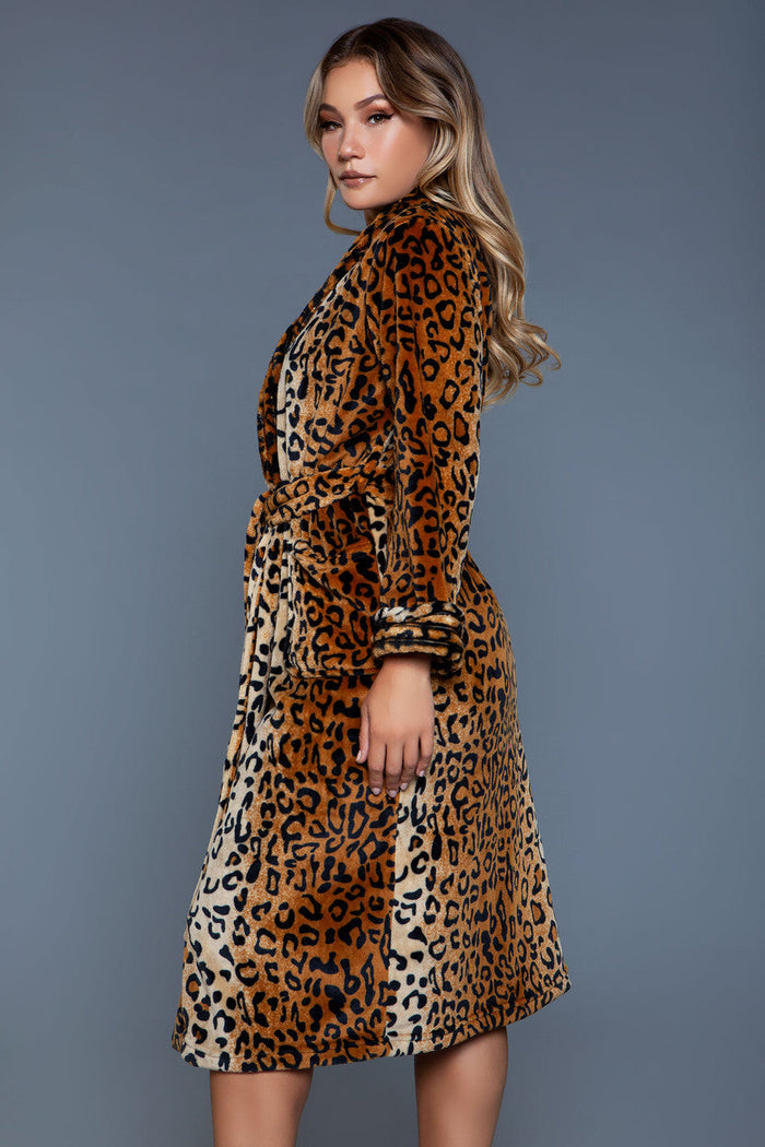 Woman wearing a leopard print dress against a gray background