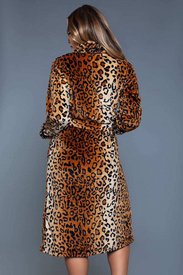 Woman wearing a leopard print dress against a gray background