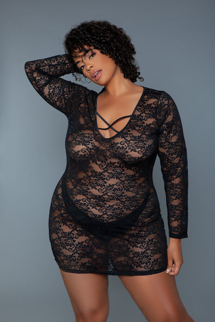 Woman wearing a black lace lingerie set against a gray background