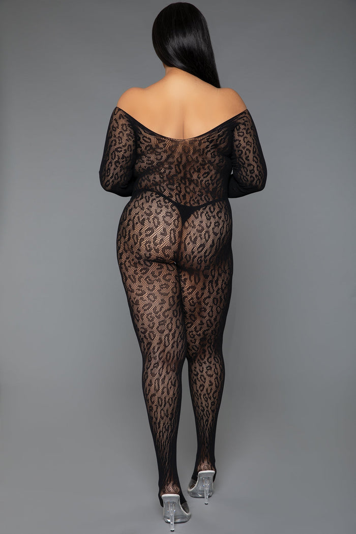 Person wearing a black leopard print bodysuit on a gray background