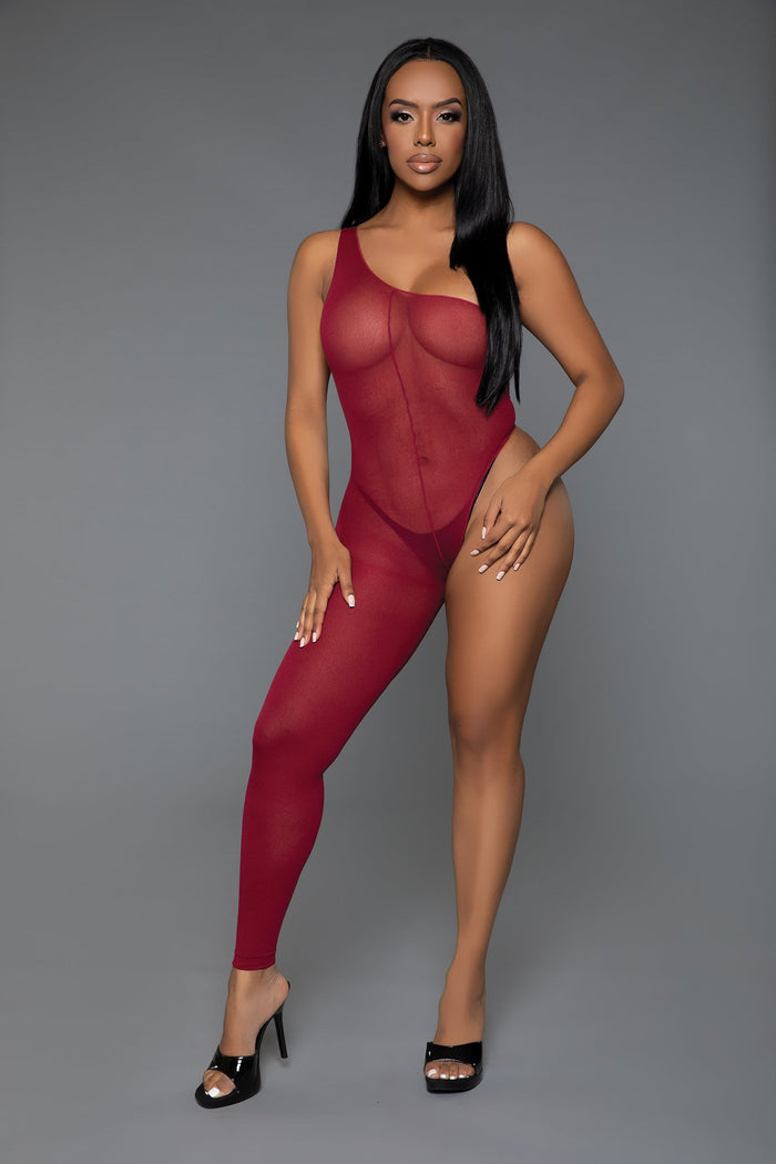 Model wearing a red bodysuit against a gray background