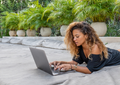 Digital nomad online English teacher delivering a virtual grammar lesson to remote language learners from tefl destinaton spot