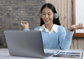 Online English teacher delivering a personalised one-to-one lesson through a virtual learning platform.
