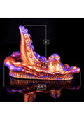Decorative copper sculpture with measurements on a black background