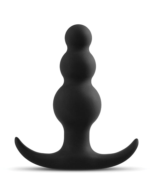 Black, curved silicone object on a white background