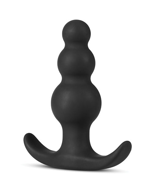Black silicone butt plug on a white background