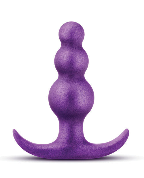 Purple silicone butt plug on a white background