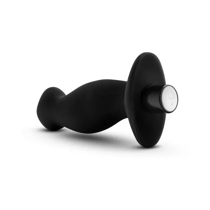 Black handheld massager on a white background