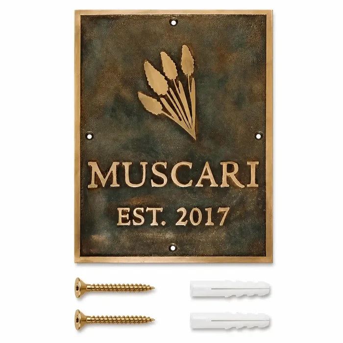 Custom brass address plaque displayed with two mounting screws and two wall anchors included for secure and easy installation.