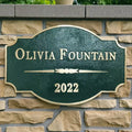 Brass address plaque nameplate on a stone wall background