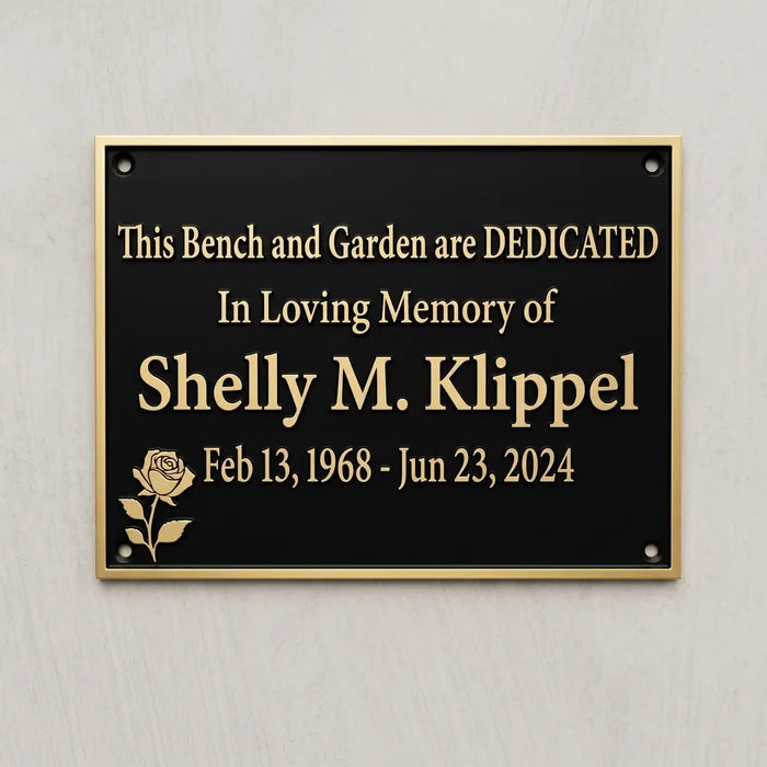 Memorial plaque dedicated to Shelly M. Klipel on a gray wall.