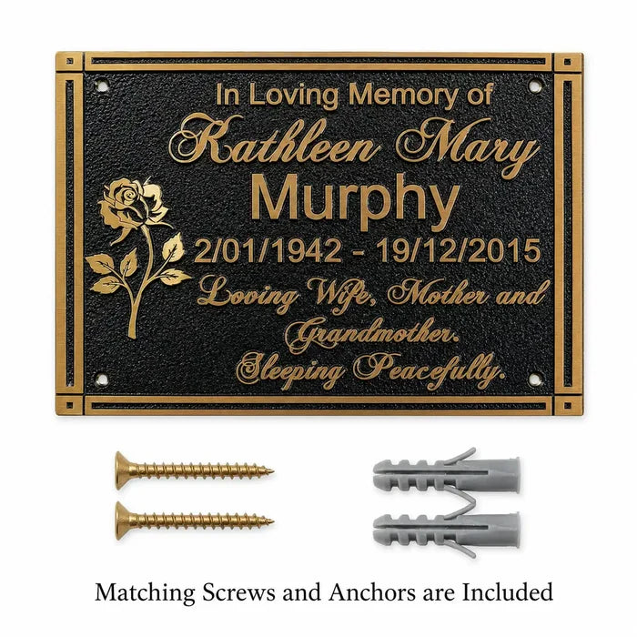 Personalized brass memorial plaque shown with matching screws and wall anchors on a clean background.