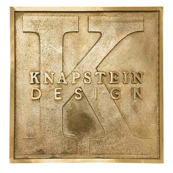 A rectangular engraved brass nameplate with the custom engraved text.