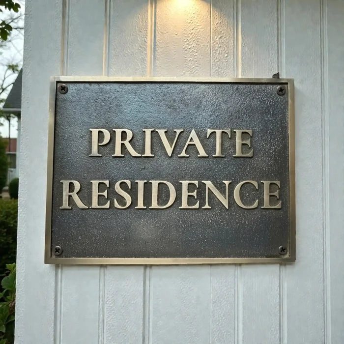 Bronze plaques - address sign on a wooden wall with 'PRIVATE RESIDENCE' text