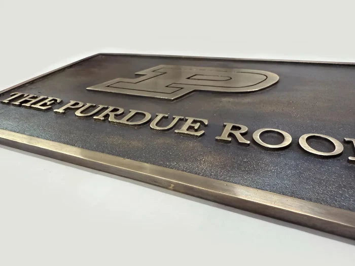 Personalized brass house number plaque with decorative border and antique finish.