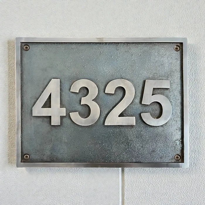 Bronze House Number Plaque - Metal house number sign with '4325' on a white wall