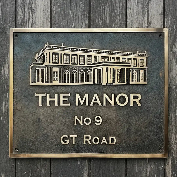 Cast bronze address plaque 3D design | Bronze sign with architectural illustration and text on a wooden background
