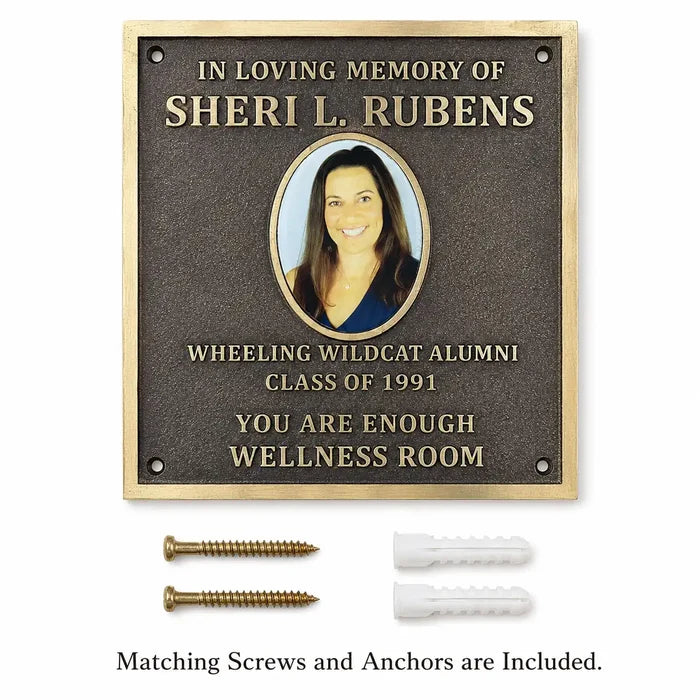 Bronze memorial plaque with engraved picture and personalized inscription displayed with mounting screws and wall anchors.