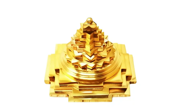 Gold-colored decorative item on a white background