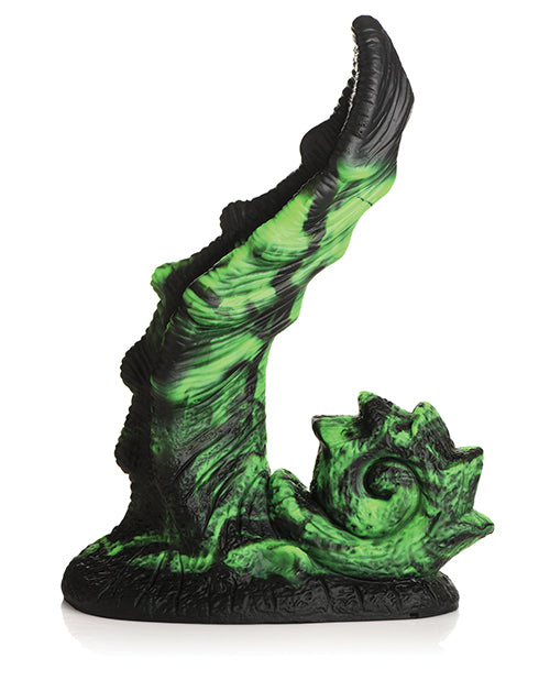 Green and black fantasy creature figurine on a white background