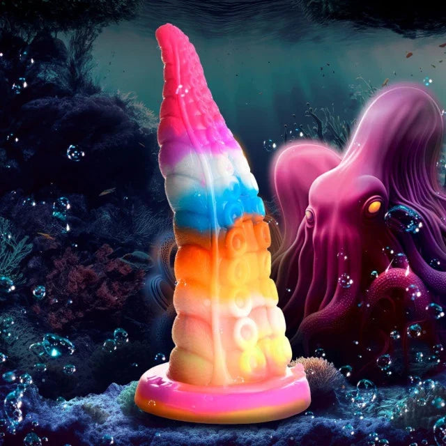 Colorful unicorn horn-shaped object with a pink base in an underwater scene.
