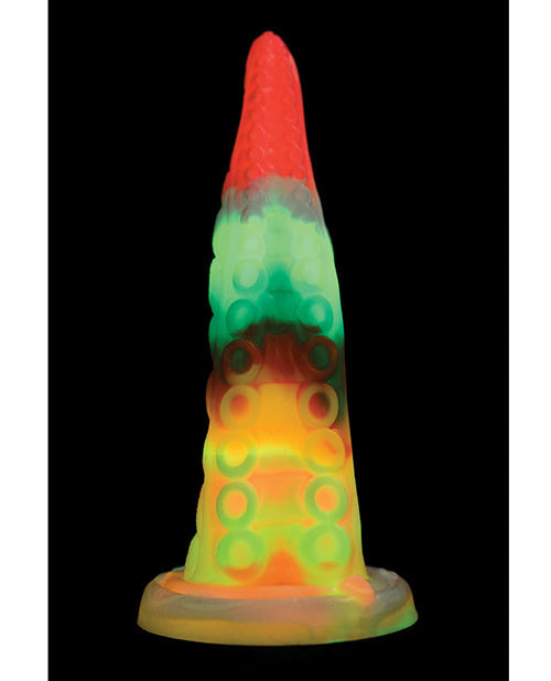 Colorful lava lamp with a red top and multicolored body on a black background