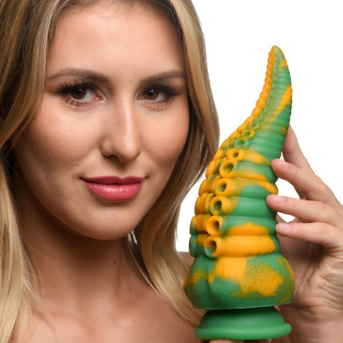 Woman holding a green and orange textured object against a white background