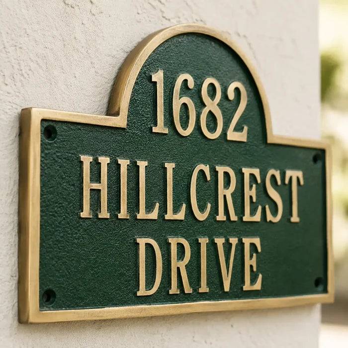 Engraved brass house number plaque with decorative top arch
