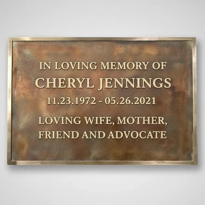 Memorial plaque for Cheryl Jennings with a bronze finish and gold text.