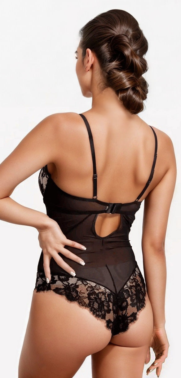 Woman wearing a black lace lingerie set on a white background