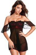 Woman wearing a black sheer dress with red accents on a white background. Sexy swinger lifestyle lingerie for a night at home or  a night at a Swinger Lifestyle event.