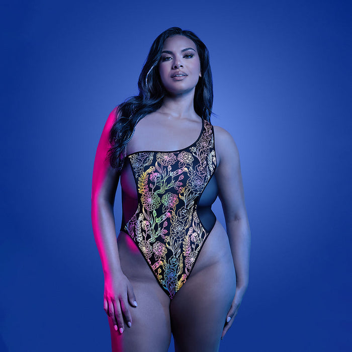 Woman wearing a colorful swimsuit against a blue background