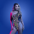 Model wearing a colorful floral-patterned bodysuit against a blue background