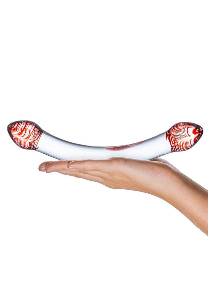 White and red object held in a hand on a white background