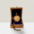 open face mechanical pocket watch on wooden box