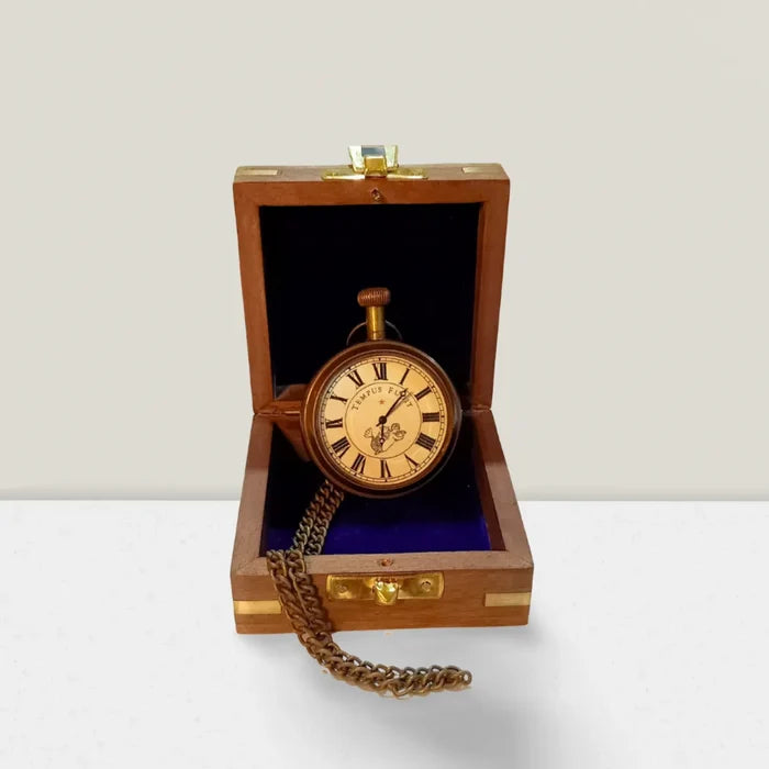 open face mechanical pocket watch on wooden box