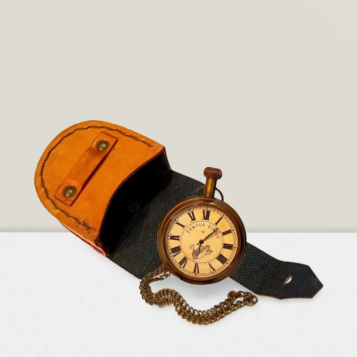 close-up of engraved mechanical pocket watch with leather case