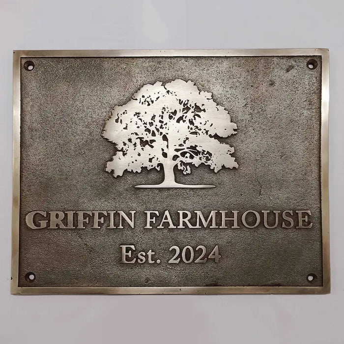 custom bronze address sign with tree design and 'Griffin Farmhouse Est. 2024' text on a gray background