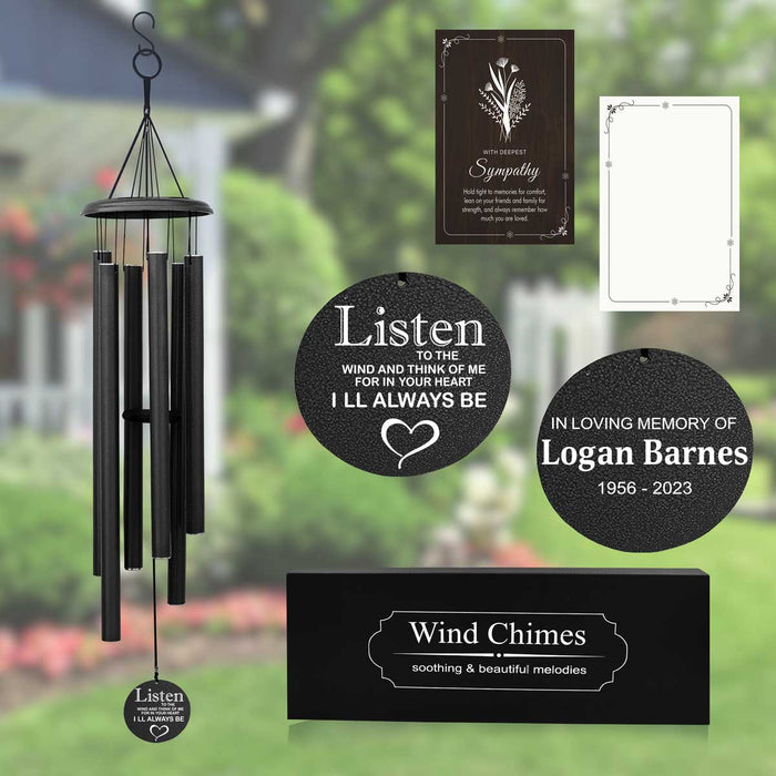 A personalized memorial wind chime with custom engraving, displayed in a garden setting. The wind chime is in black color, and the image shows various components including a hanging chain, a wind chime, and a memorial plaque with text.
