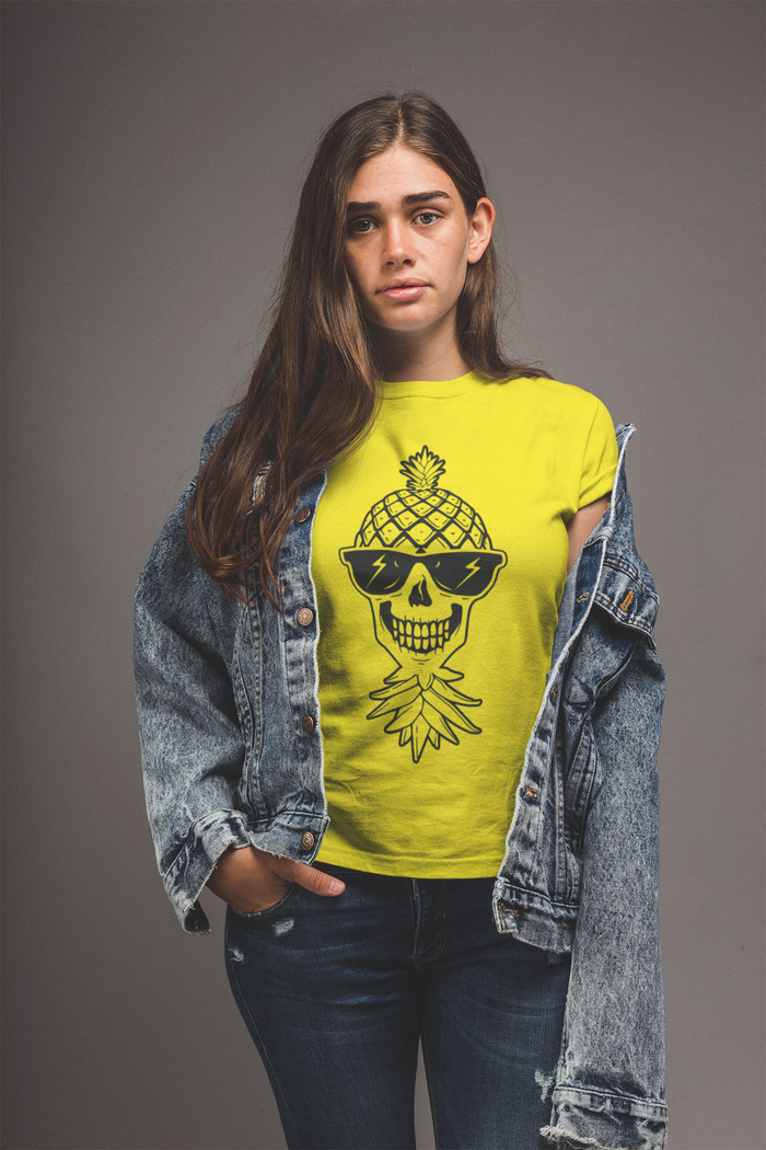 A woman wearing a yellow crew neck t-shirt with a graphic of a pineapple skull, paired with a denim jacket and blue jeans.