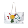 A white weekender bag with a playful pineapple design, featuring text and decorative details on the fabric.