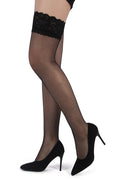 Black fishnet stockings with lace top worn with black high heels on a white background