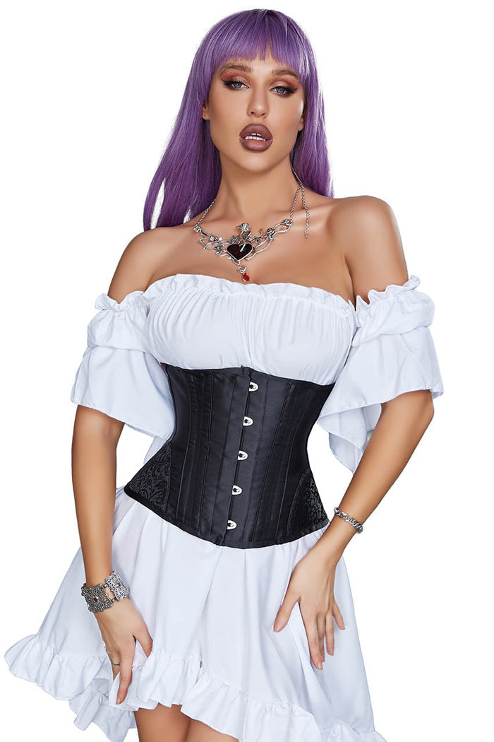 Woman wearing a black corset and white off-shoulder top with a purple wig on a white background