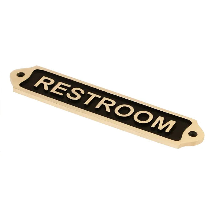 Decorative brass restroom plaque with clear engraved lettering