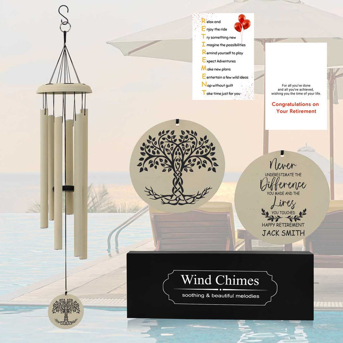 A retirement wind chime in multiple colors and sizes with a tree design on a circular wind chime piece. The surrounding area includes a plaque with a  custom message and a name.