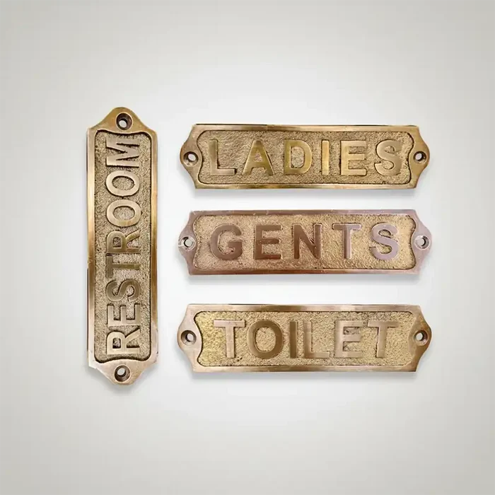 Set of 4 brass door Sign restroom signs on a light gray background